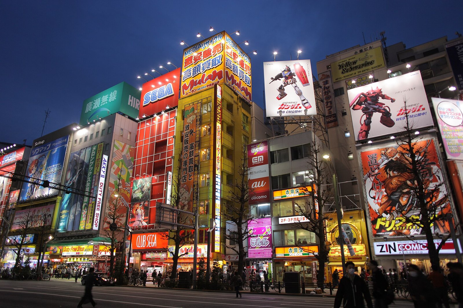 Akihabara Electric Town in Tokyo at night with bright anime and electronics store signs